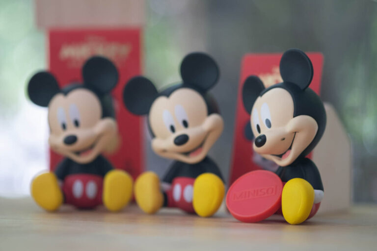 Happy Disney CX customers as shown by three Mickey Mouse toys