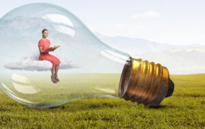 woman sitting in light bulb on top of cloud