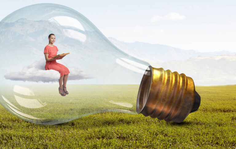 woman sitting in light bulb on top of cloud