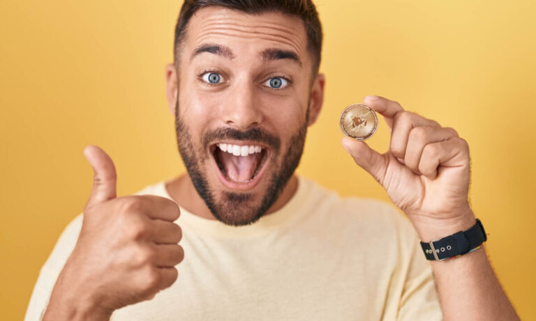 man holding coin representing cryptocurrency