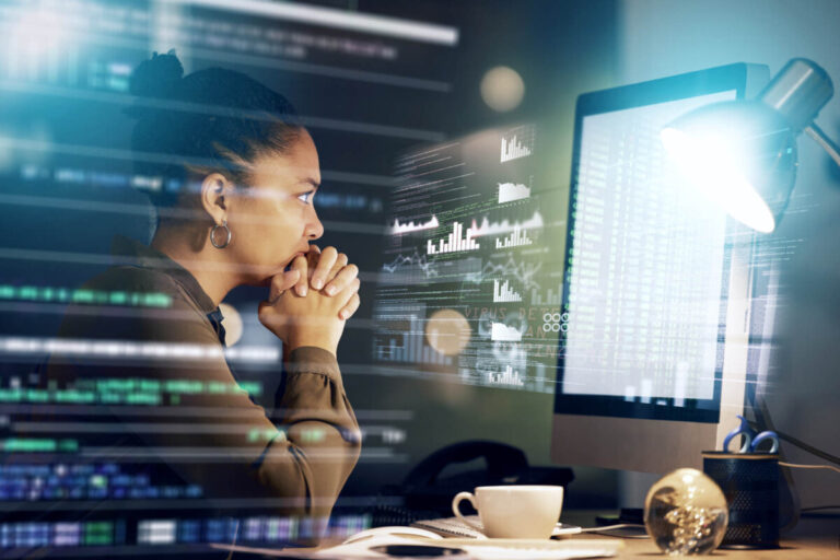 women staring at screen - top ten fintech breakthroughs 2023