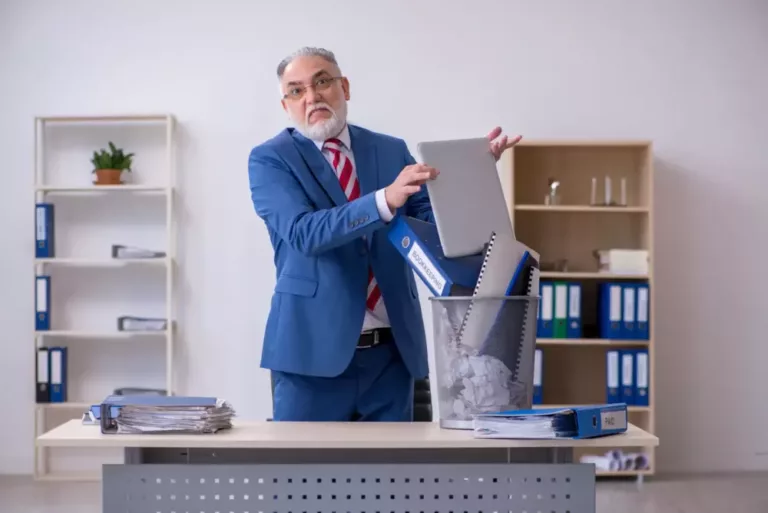 Sustainable software shown by man throwing away laptop