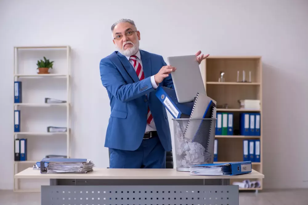 Sustainable software shown by man throwing away laptop