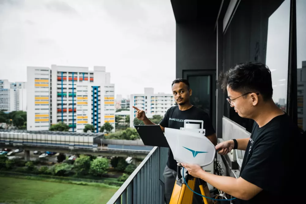 Transcelestial employees installing laser tech in Singapore