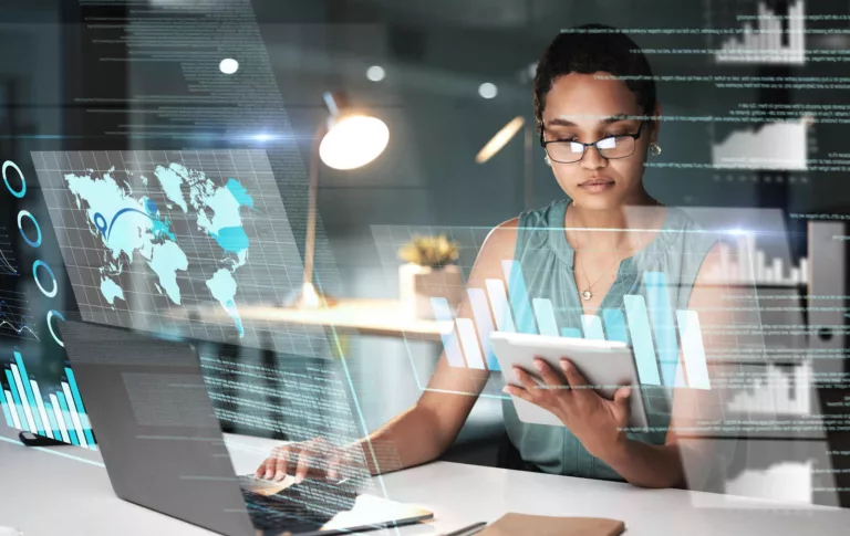 Woman looking at tablet and laptop showing best Accounting Software for mid-sized businesses