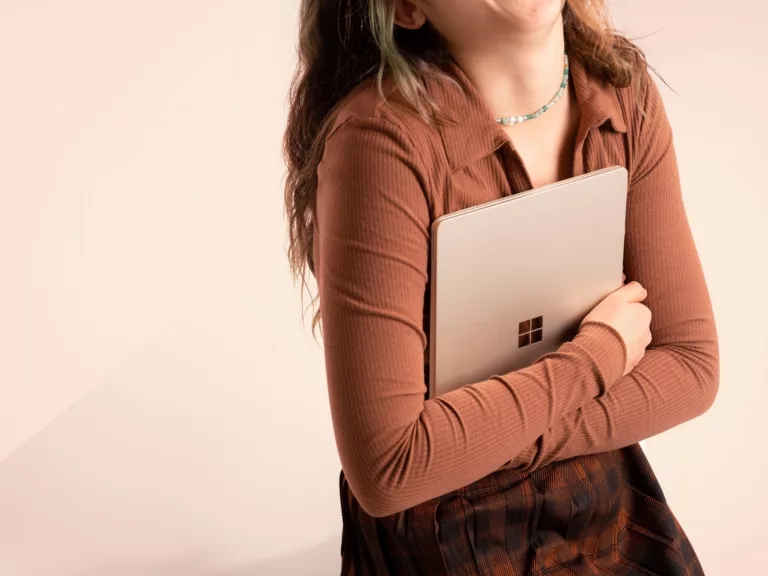 Woman holding a Microsoft Surface laptop