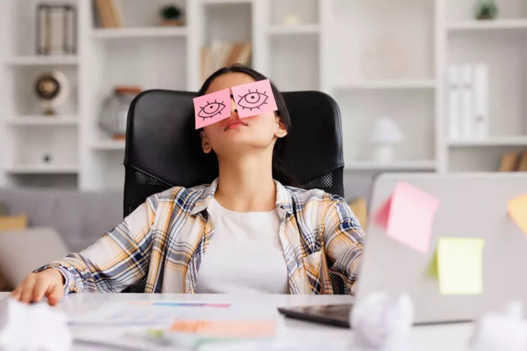 lazy girl jobs shown by woman at desk seemingly asleep