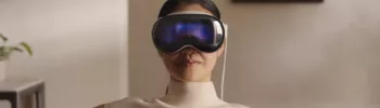 apple ai weakness - woman wearing Vision Pro glasses on sofa