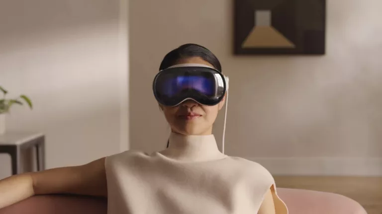 apple ai weakness - woman wearing Vision Pro glasses on sofa