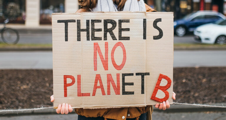 Protester with a sign that reads "There is no Planet B" at a rally against climate change. Digital Exceptionalism