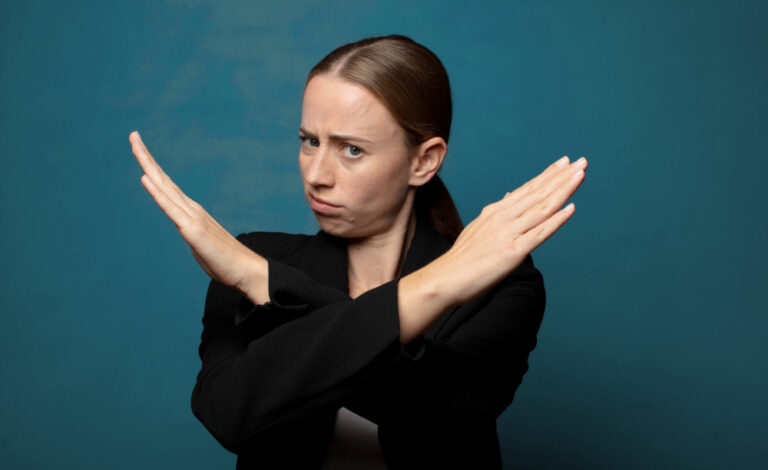 in my day thinking shown by woman looking annoyed, saying enough! with hands crossed up front, telling you to stop