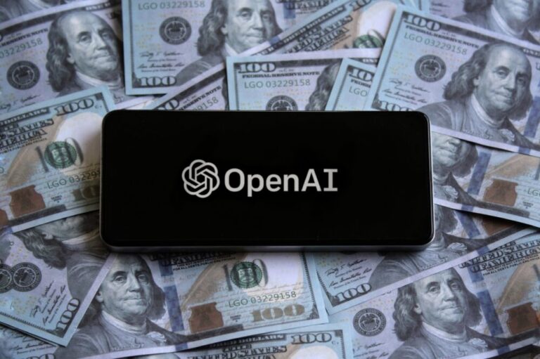 openai for-profit represented by OpenAI logo displayed on smartphone on top of pile of money.