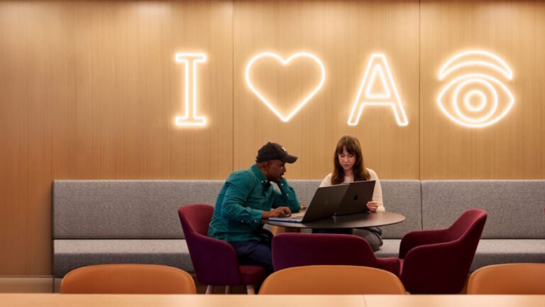 watsonx ai labs office image of workers underneath I heart A eye icons