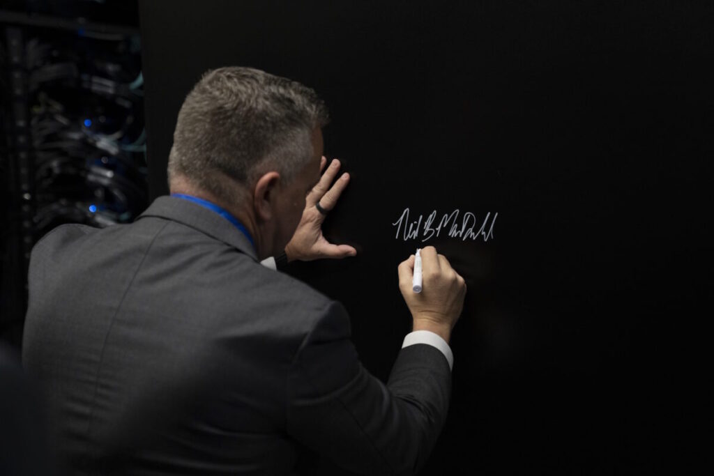 Neil MacDonald, Executive Vice President & General Manager HPE Server Business signing Isambard-AI supercomputer