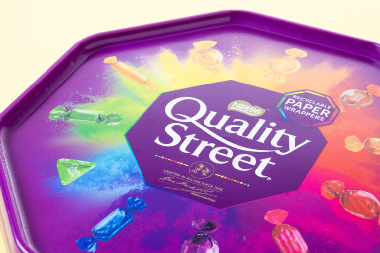 Nestle SAP Cloud upgrade illustrated by Quality Street chocolate box on yellow background