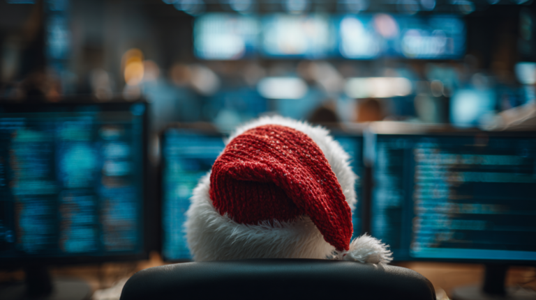 IT manager sat in front of bank of computers with Christmas hat on