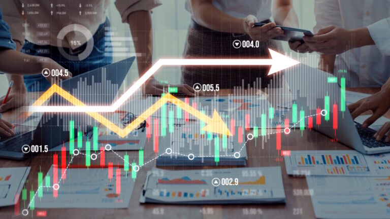 A dynamic business meeting showcasing collaboration and analysis of financial data with charts and graphs on laptops in a modern office setting. Scalp