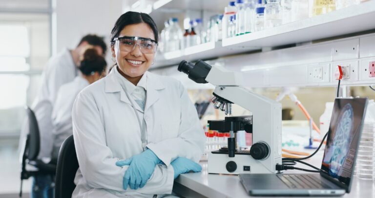 opportunities for healthcare - female technician smiling at camera in lab