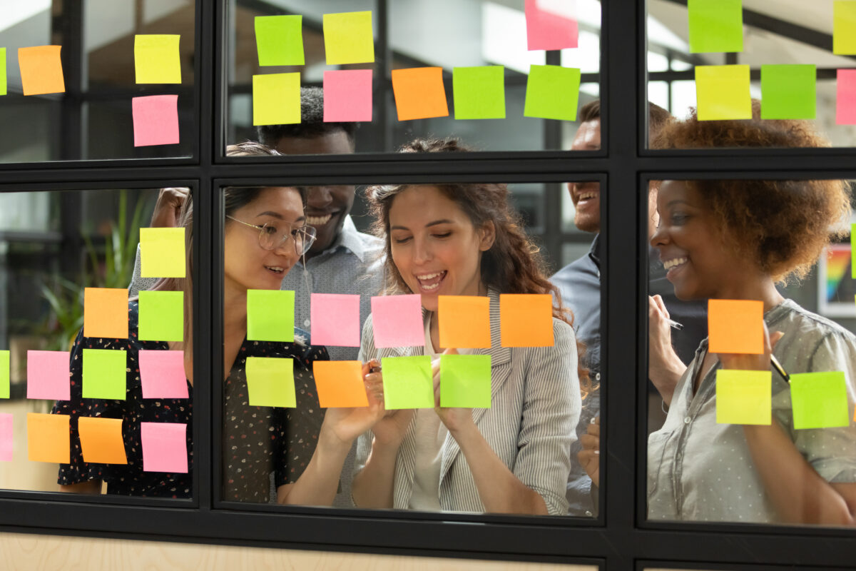 Success GenAI projects shown by young team working on kanban wall