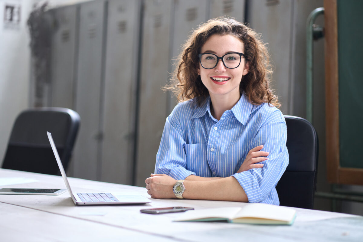 IBM impact accelerator shown by young female teacher smiling at camera
