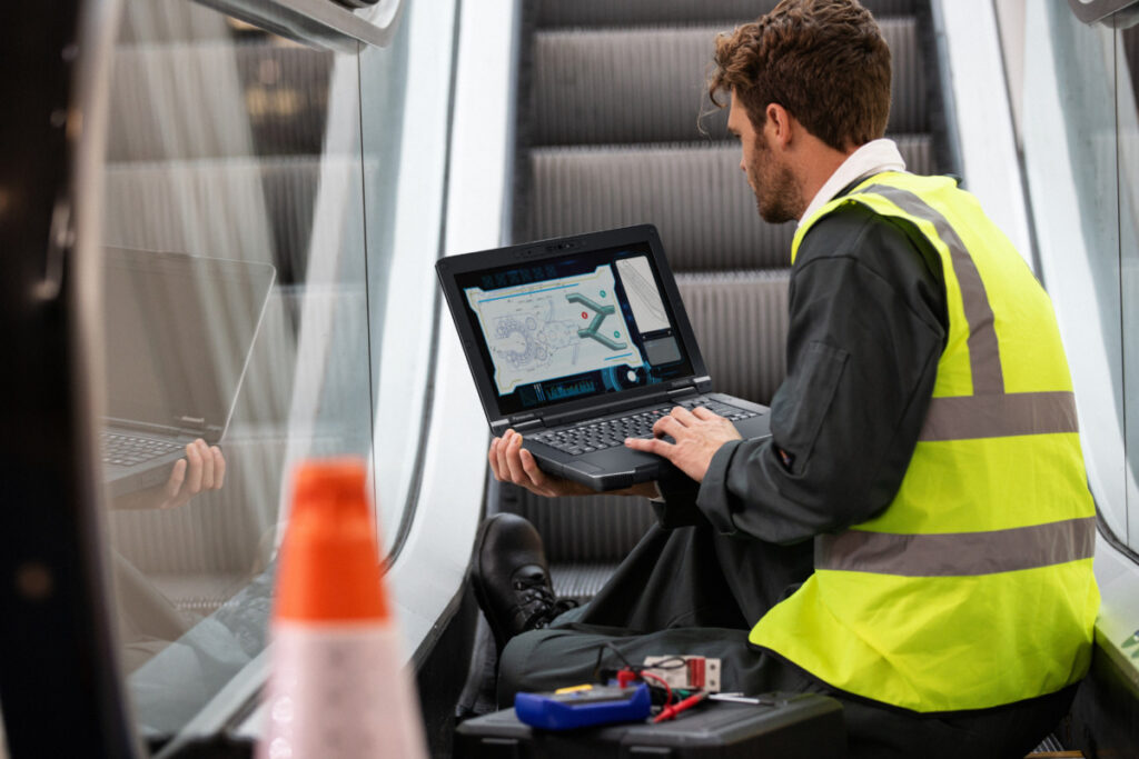 Panasonic Toughbook 56 being used by escalator repairman