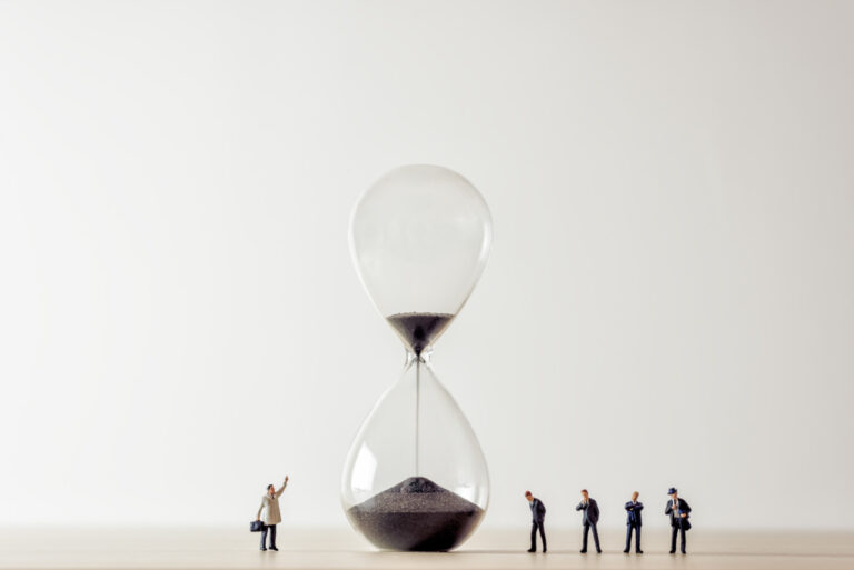 Conceptual image of business people looking at Hourglass