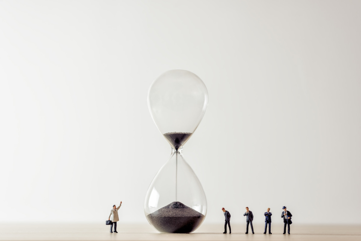 Conceptual image of business people looking at Hourglass