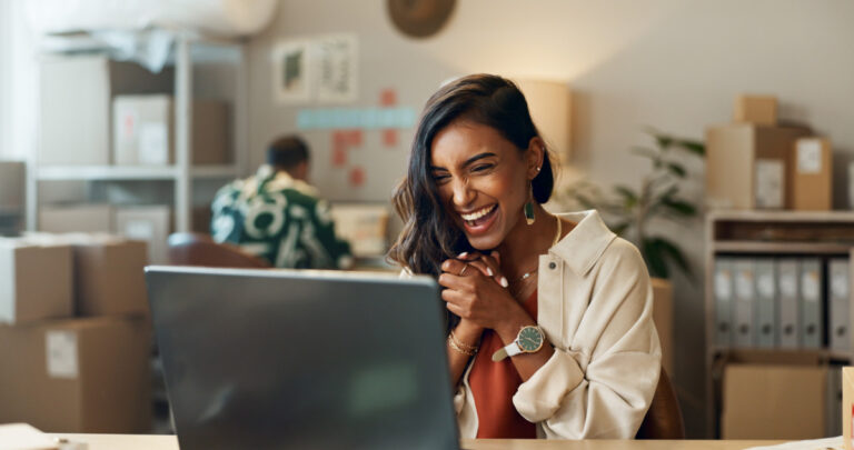 Copilot+ PCs business shown by young woman being delighted with her new laptop