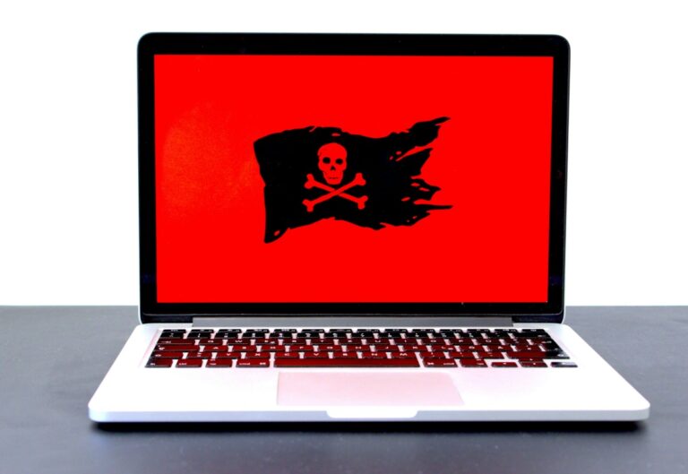 Can piracy be completely eradicated? - Laptop displaying a pirate flag / jolly roger on a red screen.