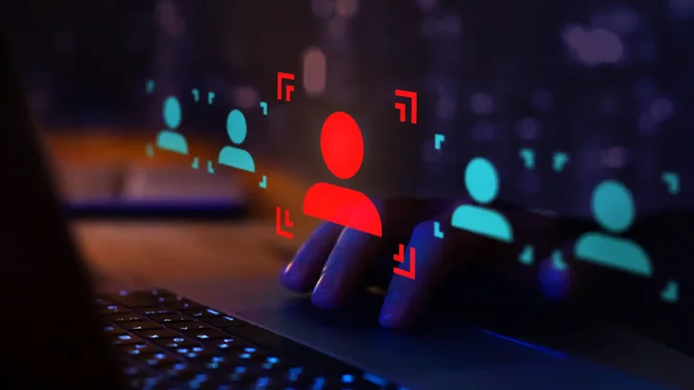 hacker at keyboard with red identity flag