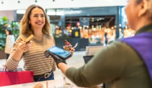 Woman making contactless credit card payment for ice cream