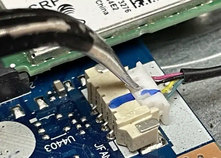 image-of-tweezers-being-used-to-remove-laptop-fan-plug