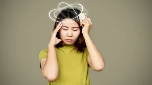 Asian woman suffering from dizziness having side effect from pills