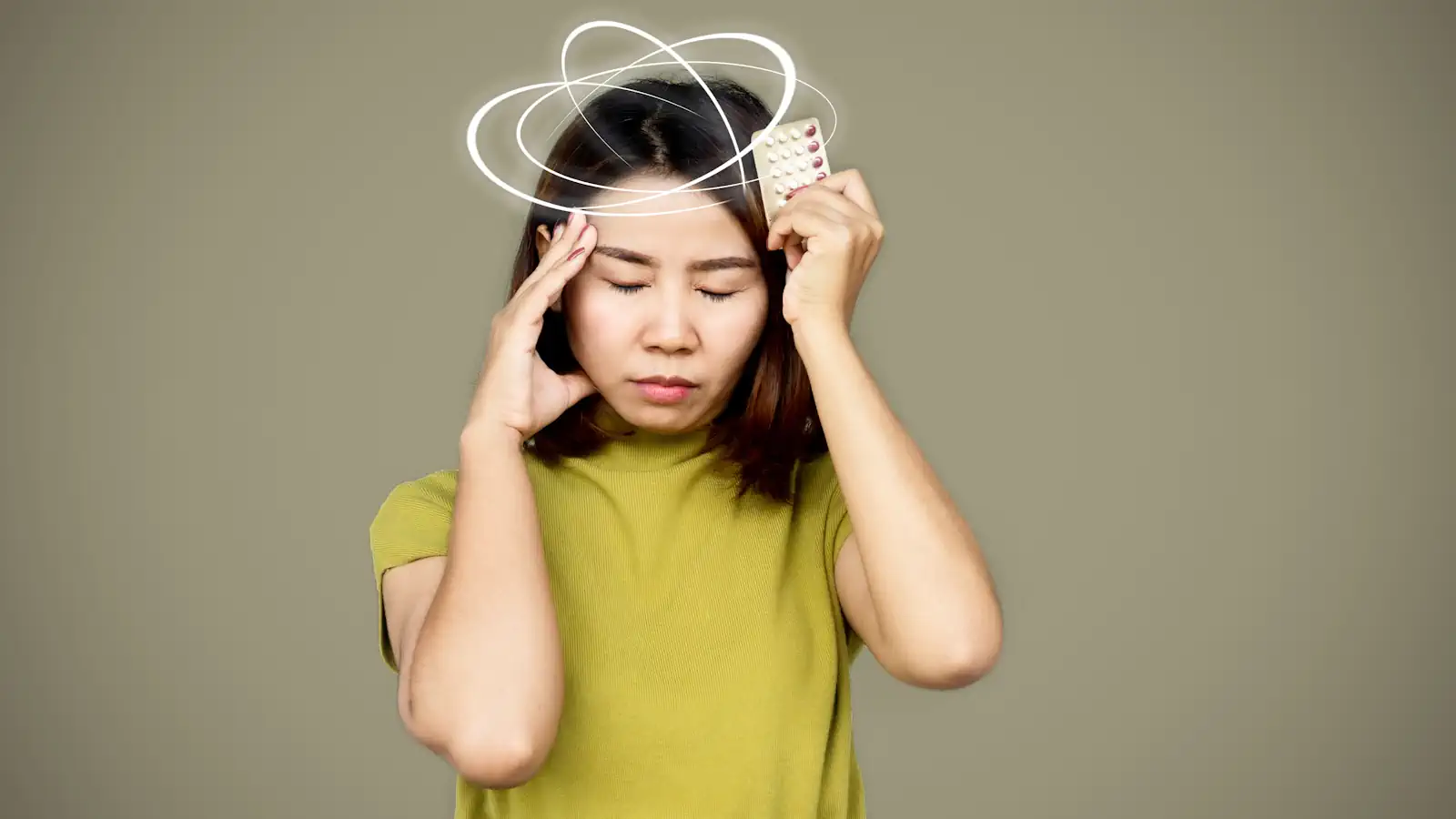 Asian woman suffering from dizziness having side effect from pills