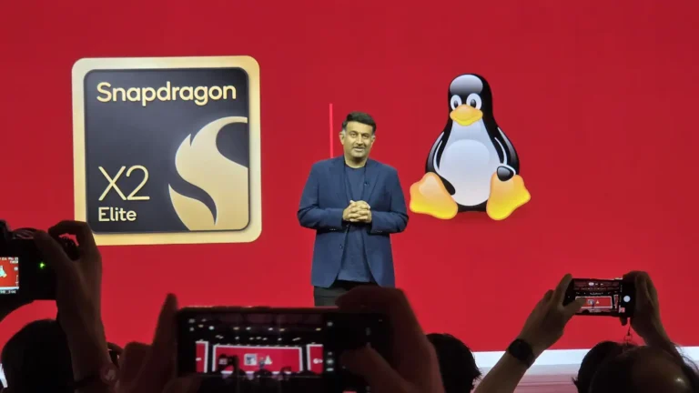 Qualcomm General Manager, Compute and Gaming, Kedar Kondap on-stage at Snapdragon Summit 2026 with Linux image behind him